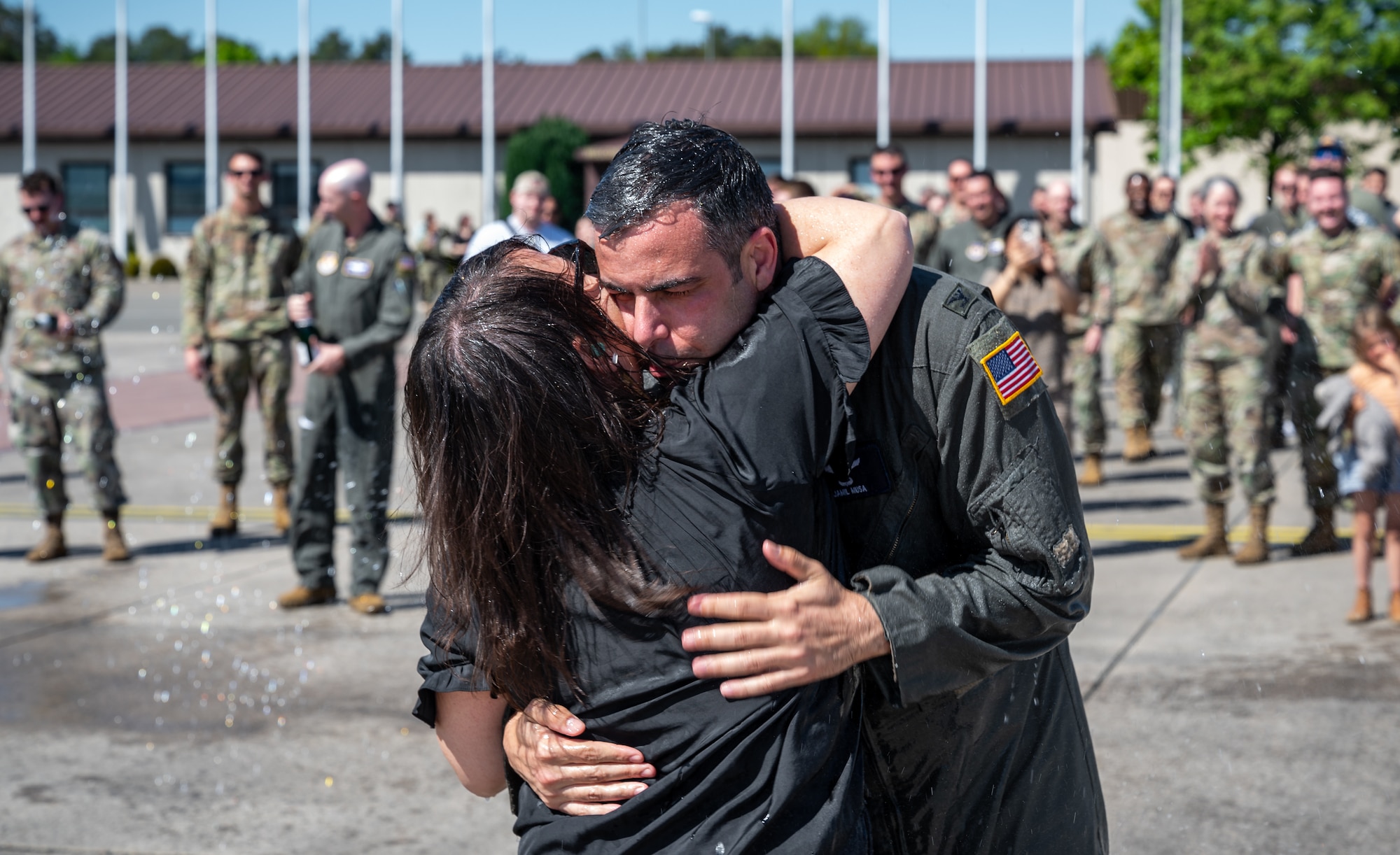 U.S. Air Force Col. Jamil I. Musa, 86th Airlift Wing deputy commander, hugs his wife DeDe after his “fini flight” at Ramstein Air Base, Germany, April 29, 2025. Upon landing, Musa was greeted by family and friends to celebrate his time at Ramstein. Musa will take command of the 436th Airlift Wing at Dover Air Base, Delaware. (U.S. Air Force photo by Senior Airman Jared Lovett)