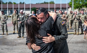 U.S. Air Force Col. Jamil I. Musa, 86th Airlift Wing deputy commander, hugs his wife DeDe after his “fini flight” at Ramstein Air Base, Germany, April 29, 2025. Upon landing, Musa was greeted by family and friends to celebrate his time at Ramstein. Musa will take command of the 436th Airlift Wing at Dover Air Base, Delaware. (U.S. Air Force photo by Senior Airman Jared Lovett)