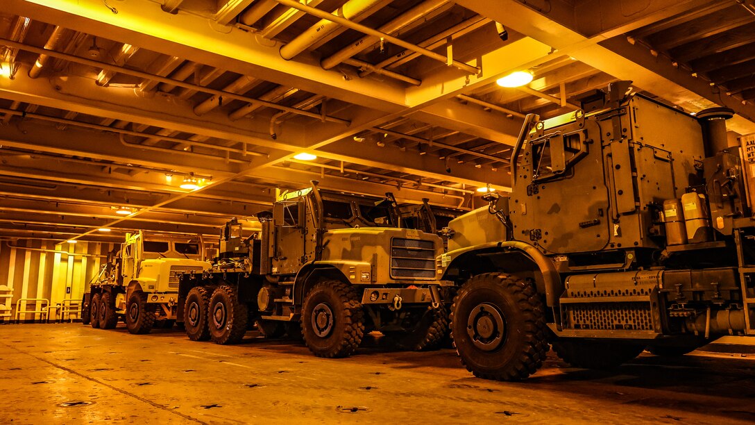 U.S. Marine Corps Maritime Prepositioning Force assets from the United States Naval Ship Seay (T-AKR 302) await offload in preparation for the Maritime Prepositioning Force Maintenance Cycle (MMC) 14 at Marine Corps Support Facility Blount Island. 

The Maritime Prepositioning Force Maintenance Cycle (MMC) is a routine process for maintaining and replenishing the equipment and supplies carried by Maritime Prepositioning Ships (MPS). It ensures the MPS remain ready for deployment and are equipped with the necessary supplies for operations. The cycle typically lasts 42 to 45 days per ship and involves checking the serviceability of the equipment and replenishing stocks.