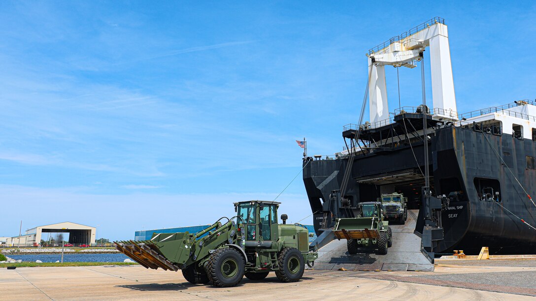 U.S. Marine Corps Maritime Prepositioning Force assets from the United States Naval Ship Seay (T-AKR 302) Roll off from the stern ramp in preparation for the Maritime Prepositioning Force Maintenance Cycle (MMC) 14 at Marine Corps Support Facility Blount Island. 

The Maritime Prepositioning Force Maintenance Cycle (MMC) is a routine process for maintaining and replenishing the equipment and supplies carried by Maritime Prepositioning Ships (MPS). It ensures the MPS remain ready for deployment and are equipped with the necessary supplies for operations. The cycle typically lasts 42 to 45 days per ship and involves checking the serviceability of the equipment and replenishing stocks.