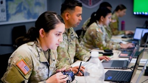 Army Specialist Samantha Zaldivar operates a homemade simulator during Chimera Sunrise