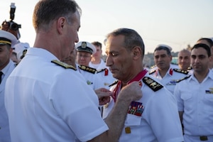 U.S. Navy Vice Adm. George Wikoff, commander of U.S. Naval Central Forces Command and U.S. Fifth Fleet, left, awards Egyptian Navy Vice Adm. Ashraf Ibrahim Atwa Megahed, commander of the Egyptian Navy, center, with a Legion of Merit medal aboard the Arleigh Burke-class guided-missile destroyer USS Truxtun (DDG 103) in the U.S. Central Command area of responsibility.