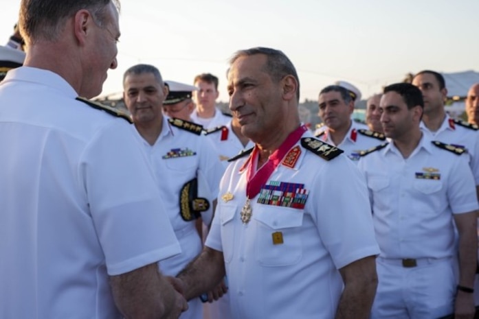 U.S. Navy Vice Adm. George Wikoff, commander of U.S. Naval Central Forces Command and U.S. Fifth Fleet, left, awards Egyptian Navy Vice Adm. Ashraf Ibrahim Atwa Megahed, commander of the Egyptian Navy, center, with a Legion of Merit medal aboard the Arleigh Burke-class guided-missile destroyer USS Truxtun (DDG 103) in the U.S. Central Command area of responsibility.