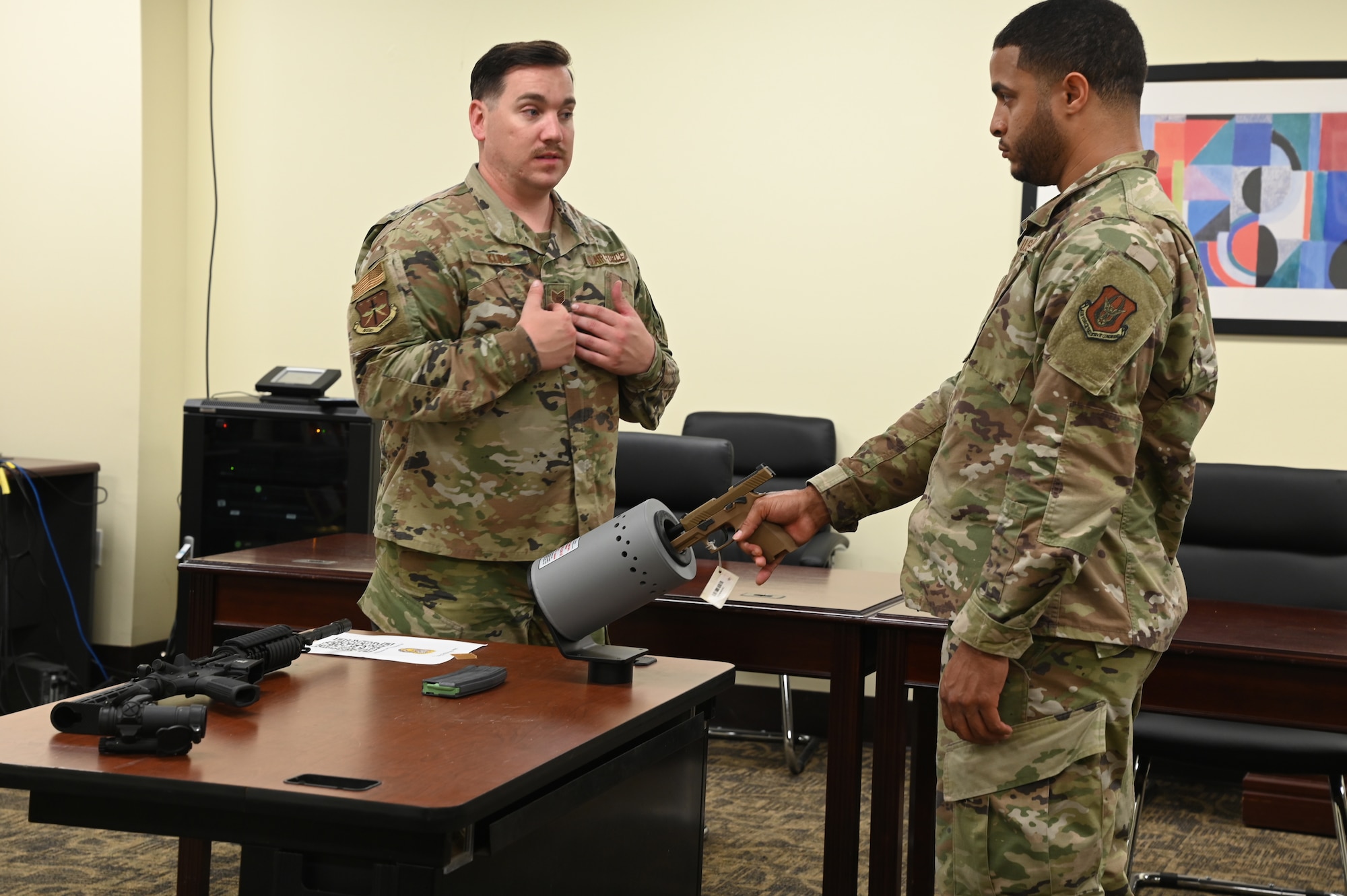 Instructor explains the clear barrel procedures to Airman.