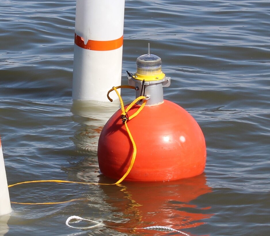 A sensor set mounted on an orange monitoring buoy, secured in place with white mooring buoys and anchors as part of the ERDC-led deployment.