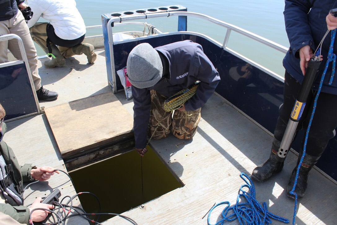Dr. Catherine Thomas (ERDC-EL) measures Secchi depth to assess water clarity during an ERDC field study.