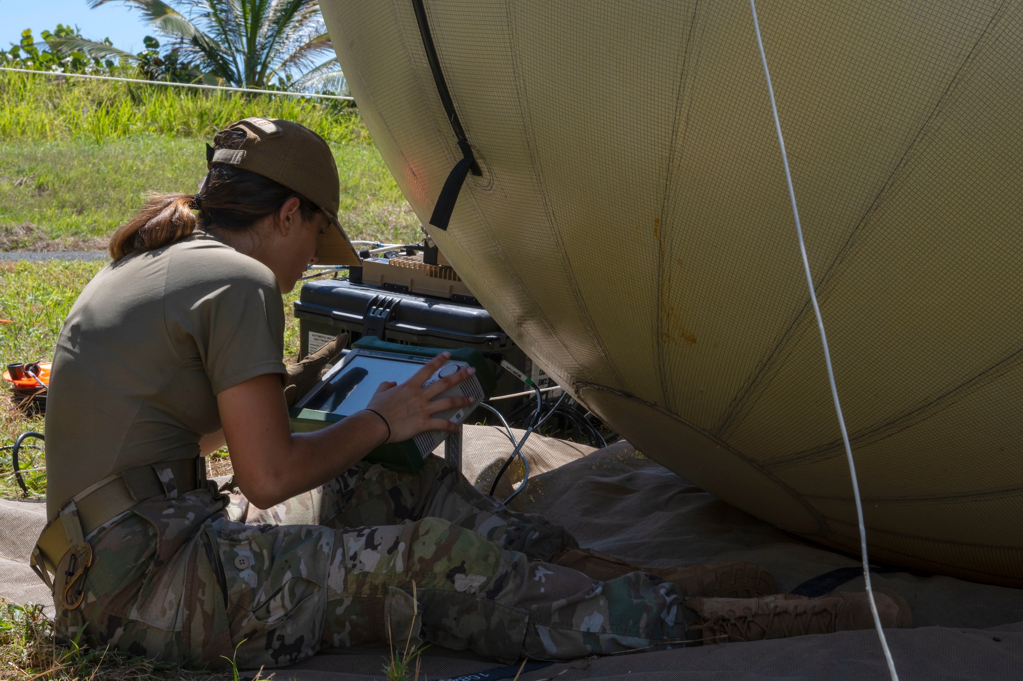 U.S. Air Force Airman 1st Class Rafaela Laguillo, a radio transmissions journeyman with the 156th Combat Communications Squadron, Puerto Rico Air National Guard, sets-up a GATOR ball antenna during a Full Operating Capability (FOC) evaluation at Punta Salinas Air National Guard Station, Toa Baja, Puerto Rico, April 24, 2025. A team of approximately 25 Airmen assigned to the 156th CBCS were evaluated on their level of proficiency in providing NIPR, SIPR, and VOIP services in an expeditionary setting as part of the FOC certification process. (U.S. Air National Guard photo by Senior Airman Victoria Jewett)