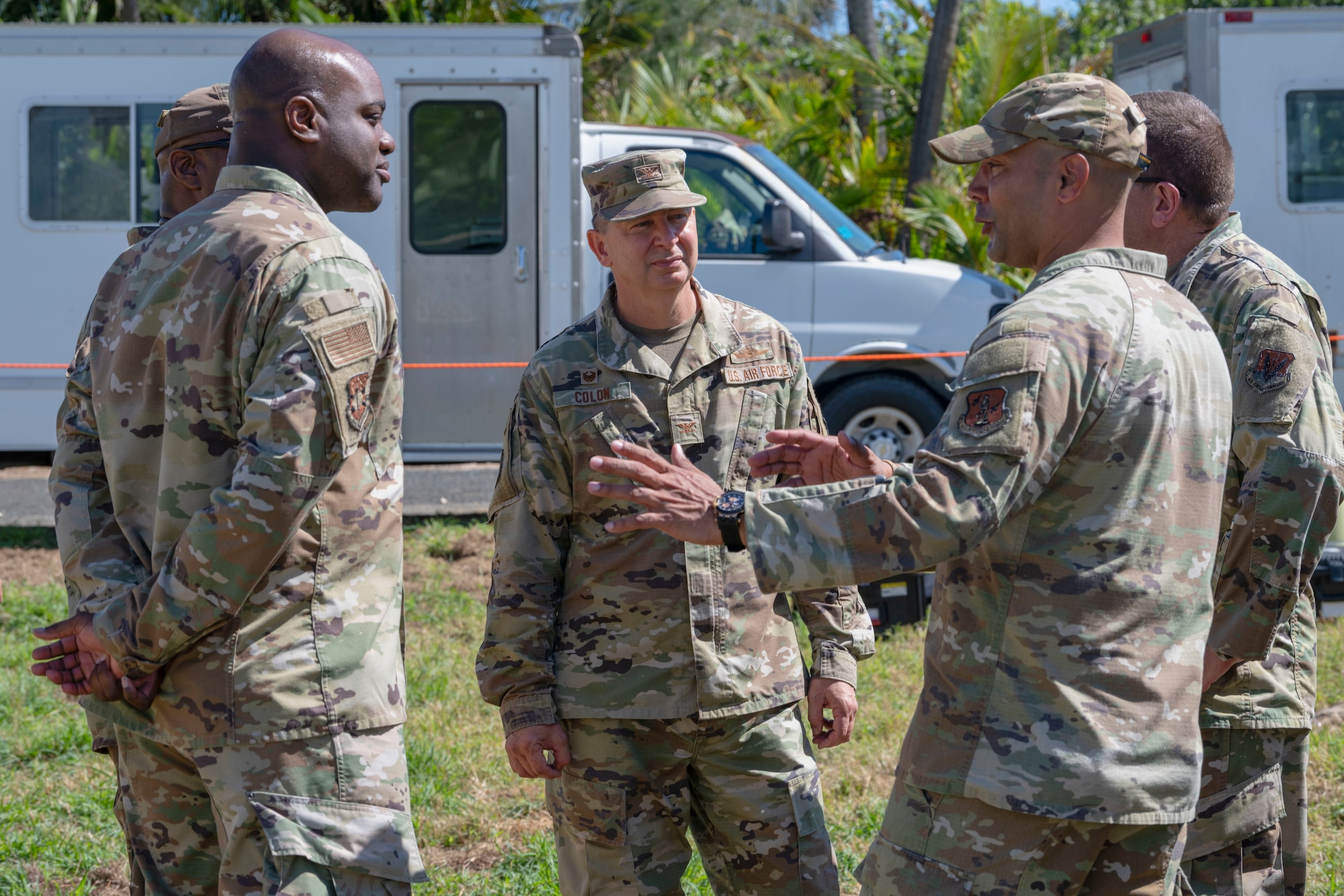 U.S. Air Force Senior Master Sgt. Jonathan Delbrey, the cyber operations superintendent with the 156th Combat Communications Squadron, Puerto Rico Air National Guard, speaks with Col. Ruben Colon, commander of the 156th Mission Support Group, and the inspectors assigned to the 226th Combat Communications Group, Abston Air National Guard Station, Alabama, during a Full Operating Capability (FOC) evaluation at Punta Salinas Air National Guard Station, Toa Baja, Puerto Rico, April 24, 2025. A team of approximately 25 Airmen assigned to the 156th CBCS were evaluated on their level of proficiency in providing NIPR, SIPR, and VOIP services in an expeditionary setting as part of the FOC certification process. (U.S. Air National Guard photo by Senior Airman Victoria Jewett)