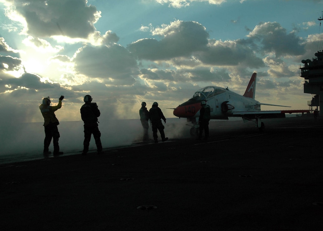 Aviation Boatswains Mate directs an T-45 Goshawk