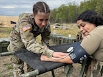 U.S. Army Spc. Caitlyn Morrison, left, and Spc. Maria Diaz, combat medics with the 108th Medical Company Area Support, 213th Regional Support Group, Pennsylvania National Guard practice medical skills during an exercise at Fort Indiantown Gap, Pennsylvania, May 3, 2025. The 108th MCAS spent time in the field to remain capable and adaptable while improving their medical and basic Soldier skills.