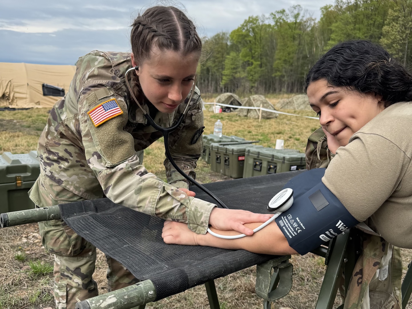 U.S. Army Spc. Caitlyn Morrison, left, and Spc. Maria Diaz, combat medics with the 108th Medical Company Area Support, 213th Regional Support Group, Pennsylvania National Guard practice medical skills during an exercise at Fort Indiantown Gap, Pennsylvania, May 3, 2025.