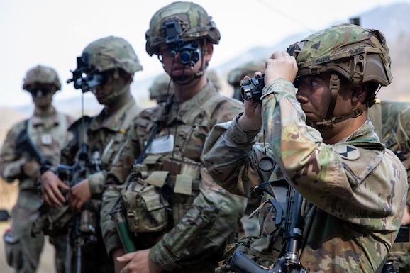 U.S. Army Sgt John Houser, assigned to 1-2 Stryker Brigade Combat Team, 7th Infantry Division, adjusts his night optical/observation devices mounted on his Next Generation Integrated Helmet Protection System April 10, 2025, at Camp Casey, Republic of Korea. For nearly a decade, the DLA Troop Support’s Clothing and Textiles team worked to get service members lighter and more protective combat helmets. (U.S. Army photo by Spc. Justin Yarborough)