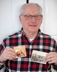 U.S. Army Sgt. David Coburn (Ret), Vermont National Guard holds two photos of his time as a heavy equipment operator in Vietnam.
