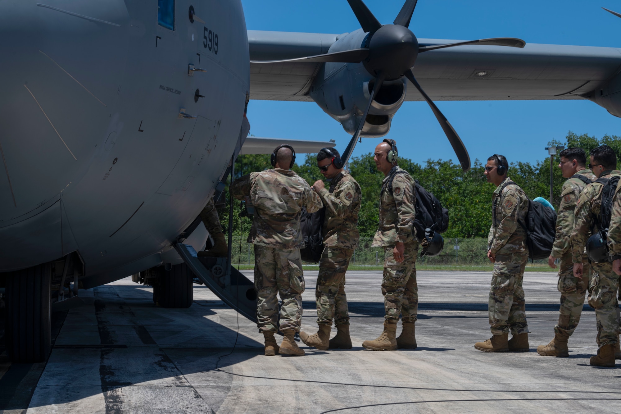 U.S. Airmen assigned to the 156th Combat Communications Squadron, Puerto Rico Air National Guard, board a C-130J Super Hercules aircraft assigned to the 123rd Airlift Wing, Kentucky Air National Guard, during the CBCS team departure at the 156th Wing airfield, Muñiz Air National Guard Base, Carolina, Puerto Rico, April 23, 2025. A team of approximately 25 Airmen assigned to the 156th CBCS traveled to Robins Air Force Base, Atlanta, Georgia to be evaluated on their level of proficiency in providing NIPR, SIPR, and VOIP services in an expeditionary setting as part of the Full Operating Capability (FOC) certification process. (U.S. Air National Guard photo by Senior Airman Victoria Jewett)