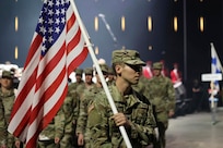 U.S. Army Spc. Caleb Hunter, Maine National Guard, leads team U.S.A. with the flag over his shoulder during the opening ceremony of the CISM 2025 World Winter Military Games