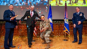 Col. Ryan Skaggs sets off a confetti cannon before receiving the NASIC Spirit Award of the Year for WM.