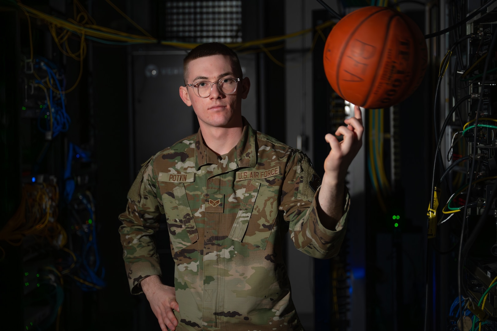 U.S. Air National Guard Senior Airman Landon Potvin, an operations support specialist assigned to the 158th Fighter Wing, pauses his duties to take an environmental portrait for an airman spotlight story