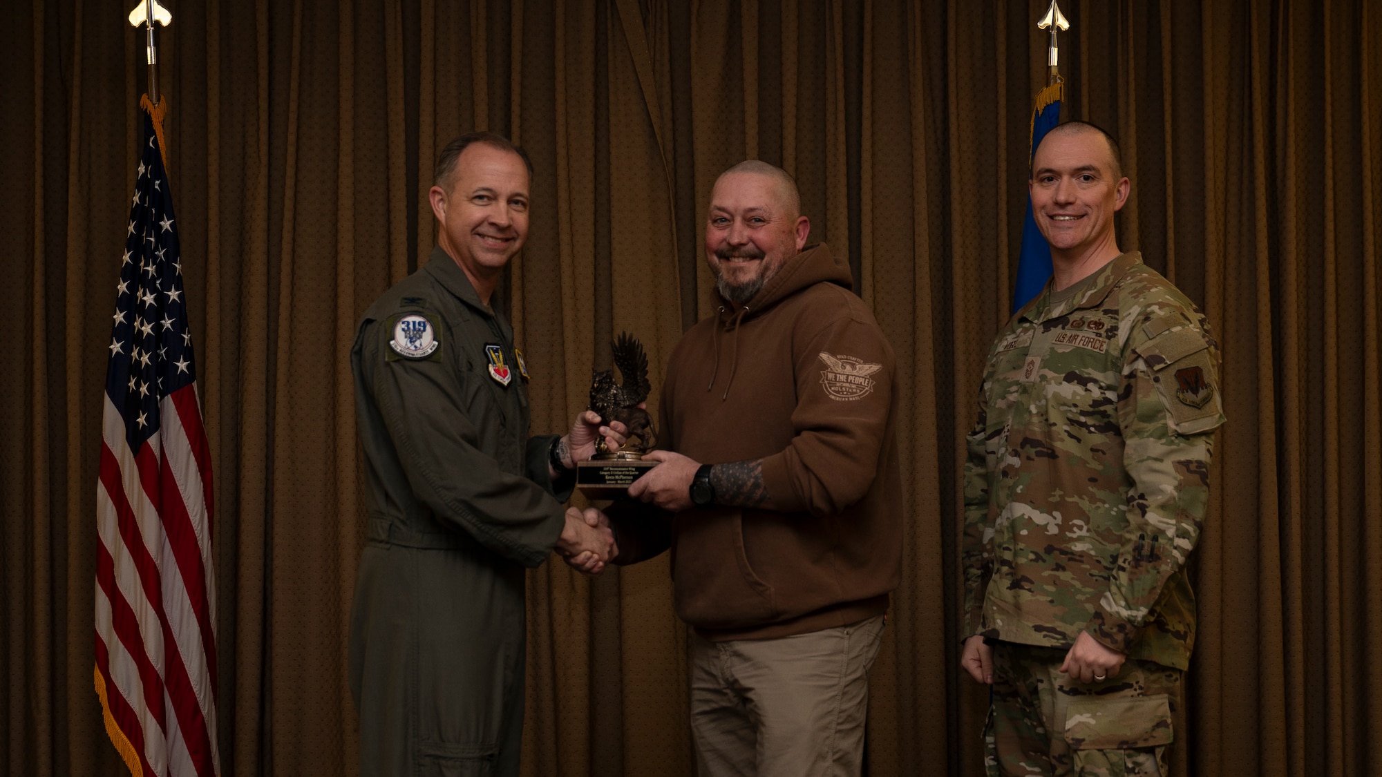 Mr. Kevin McPherson, 319th Logistic Readiness Squadron, accepts the Category II Civilian of the Quarter Award, during the 319th Reconnaissance Wing’s 1st quarter award ceremony at Grand Forks Air Force Base, North Dakota, May 2, 2025.