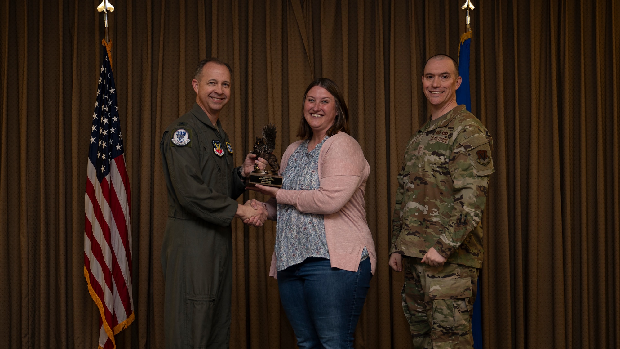 Ms. Jessica Johnson, 319th Comptroller Squadron, accepts the Category III Civilian of the Quarter Award, during the 319th Reconnaissance Wing’s 1st quarter award ceremony at Grand Forks Air Force Base, North Dakota, May 2, 2025.