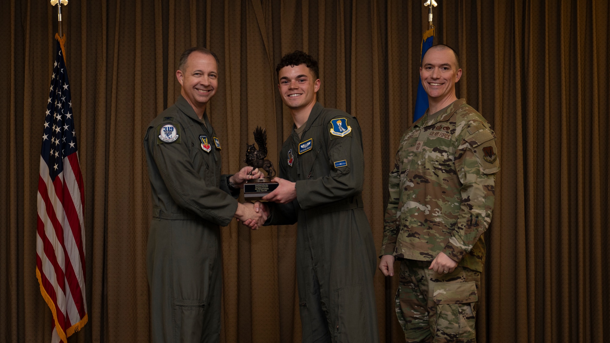 Airman 1st Class Michael Graham, 348th Reconnaissance Squadron, accepts the Dorm of the Quarter Award, during the 319th Reconnaissance Wing’s 1st quarter award ceremony at Grand Forks Air Force Base, North Dakota, May 2, 2025.