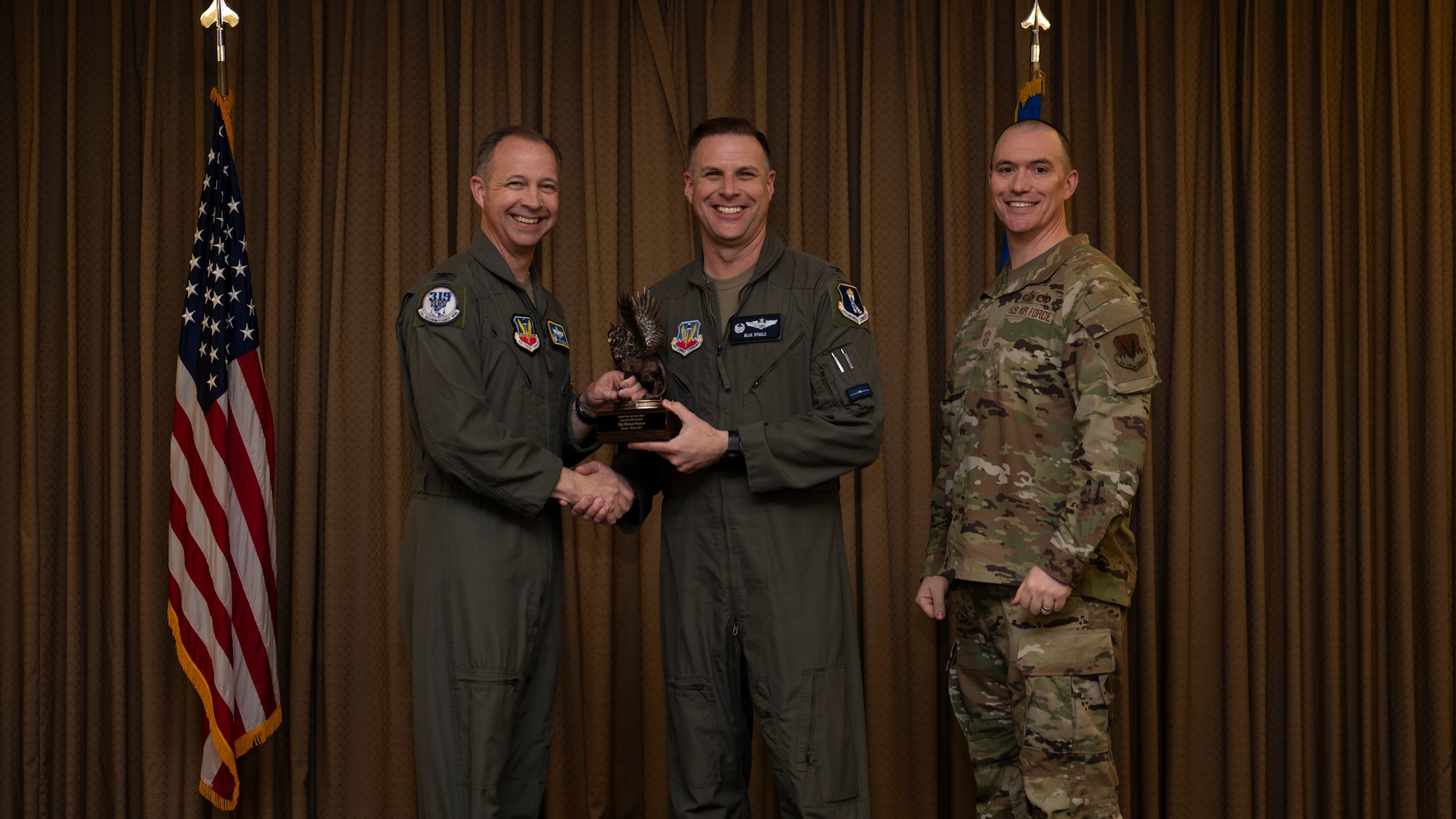Col. Eric Steele, 319th Operations Group Commander, accepts the Inspector of the Quarter Award on behalf of Staff Sgt. Michael Monroe, 7th Reconnaissance Squadron, during the 319th Reconnaissance Wing’s 1st quarter award ceremony at Grand Forks Air Force Base, North Dakota, May 2, 2025.