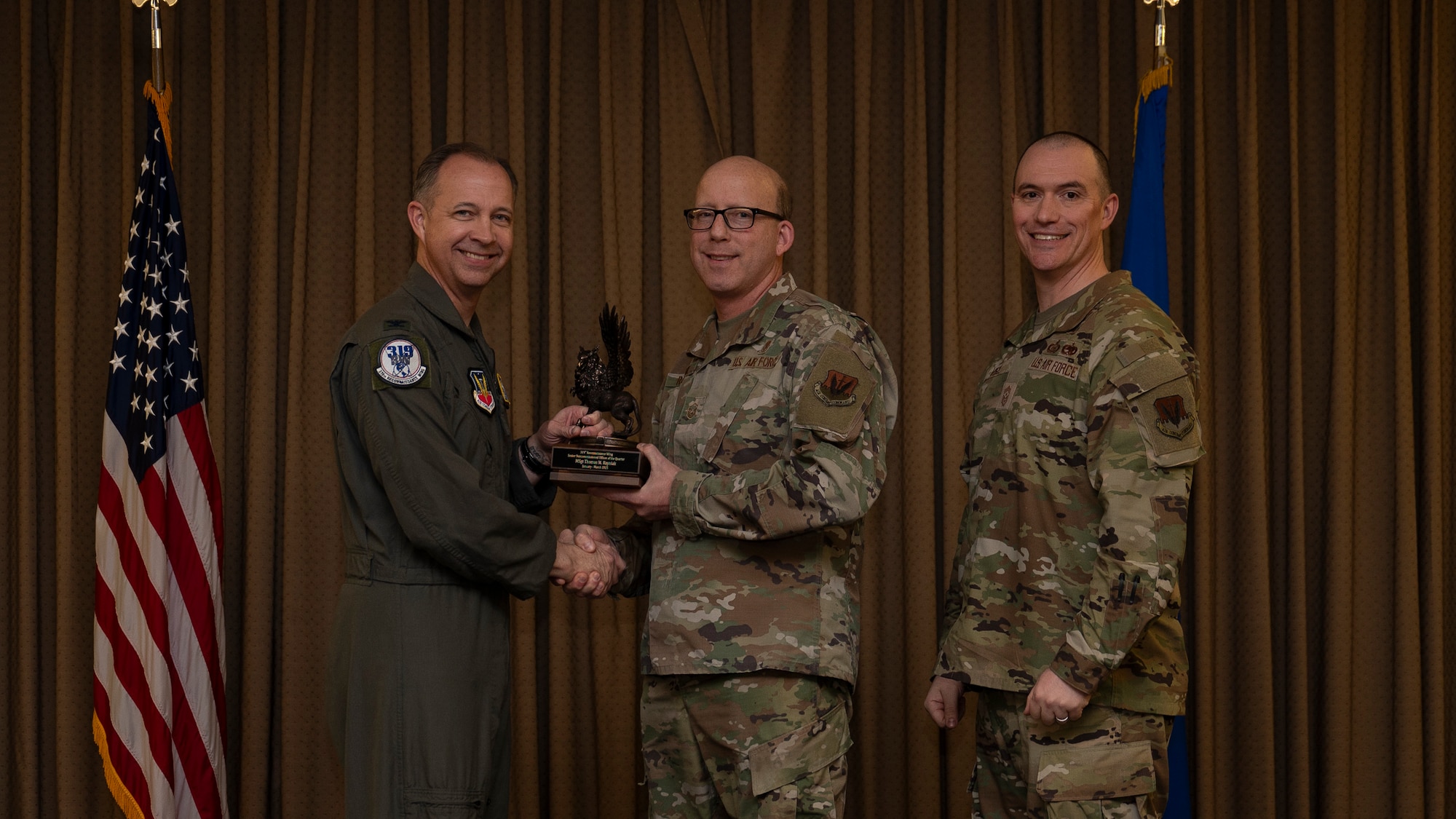 Master Sgt. Thomas M. Rayniak, Healthcare Operations Squadron, accepts the Senior Non-commissioned Officer of the Quarter Award, during the 319th Reconnaissance Wing’s 1st quarter award ceremony at Grand Forks Air Force Base, North Dakota, May 2, 2025.