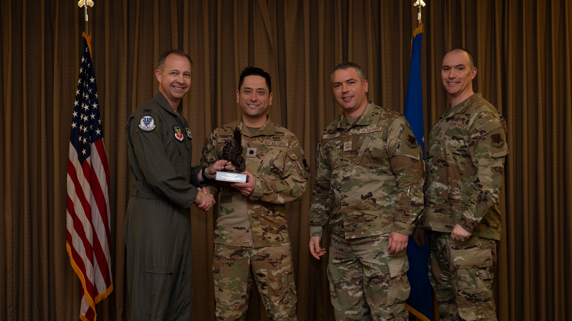 Members from the 319th Operations Support Squadron, accept the Unit of the Quarter Award, during the 319th Reconnaissance Wing’s 1st quarter award ceremony at Grand Forks Air Force Base, North Dakota, May 2, 2025.