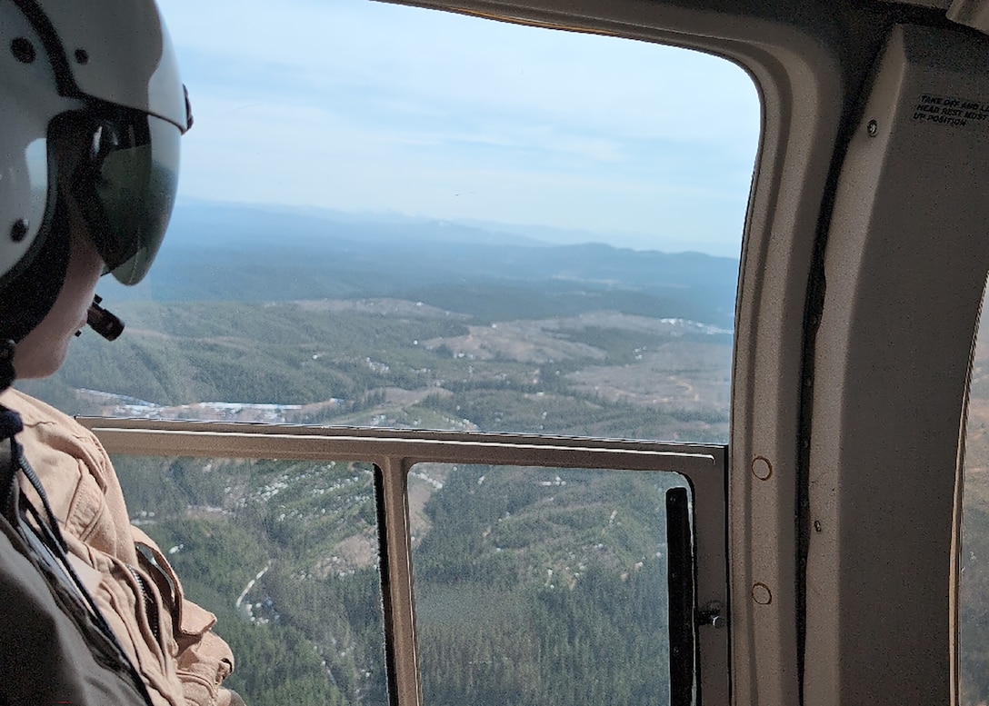 Willow Walker, a reservoir regulator, Water Management Section, Walla Walla District, U.S. Army Corps of Engineers, looks across the landscape above Saint Louis Gulch, a valley, 3,215 feet above sea level, in Clearwater County Idaho, during the Walla Walla District's annual snow flight, April 10. Conducted in collaboration with the Idaho Natural Resources Conservation Service, U.S. Department of Agriculture, this mission helps engineers with the Water Management Team of the Walla Walla District, assess mountain snowpack—nature’s high-altitude water reserve—crucial for forecasting regional water flow that sustains rivers, farms, and communities.