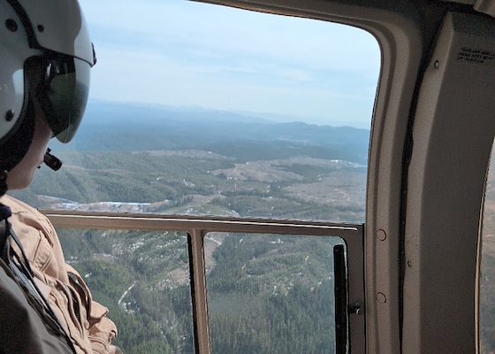 Willow Walker, a reservoir regulator, Water Management Section, Walla Walla District, U.S. Army Corps of Engineers, looks across the landscape above Saint Louis Gulch, a valley, 3,215 feet above sea level, in Clearwater County Idaho, during the Walla Walla District's annual snow flight, April 10. Conducted in collaboration with the Idaho Natural Resources Conservation Service, U.S. Department of Agriculture, this mission helps engineers with the Water Management Team of the Walla Walla District, assess mountain snowpack—nature’s high-altitude water reserve—crucial for forecasting regional water flow that sustains rivers, farms, and communities.