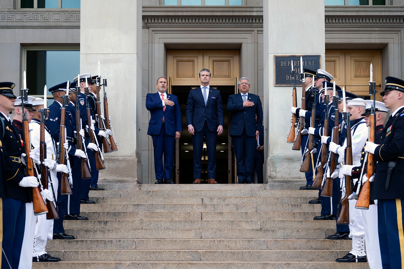 Defense Secretary Pete Hegseth, Peruvian Minister of Defense Walter Astudillo and Minister of Foreign Affairs Elmer Schialer stand on the steps of the Pentagon during a ceremony.