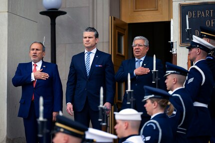 A close-up of three U.S. and Peruvian defense leaders during a ceremony at the Pentagon.
