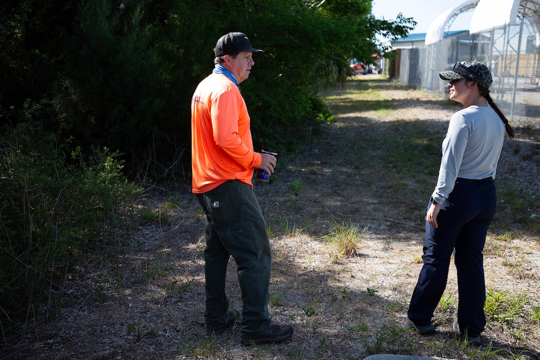 Dave Yow, an Environmental Resource Solutions wildlife biologist, discusses gopher tortoises with Taylor Comstock, Marine Corps environmental protection specialist, during a burrow survey May 2, 2025, along the St. Johns River at Marine Corps Support Facility Blount Island, Florida. (Official U.S. Marine Corps Photo/Dustin Senger)