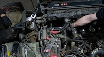 Airmen assigned to the 5th Logistics Readiness Squadron vehicle maintenance flight replace parts on a High Mobility Multipurpose Wheeled Vehicle (Humvee) alternator at Minot Air Force Base, North Dakota, April 30, 2025. The Humvee has a maximum speed of 70 mph depending on the configuration and has an effective range of 300 miles. (U.S. Air Force photo by Airman 1st Class Wesley Davies)