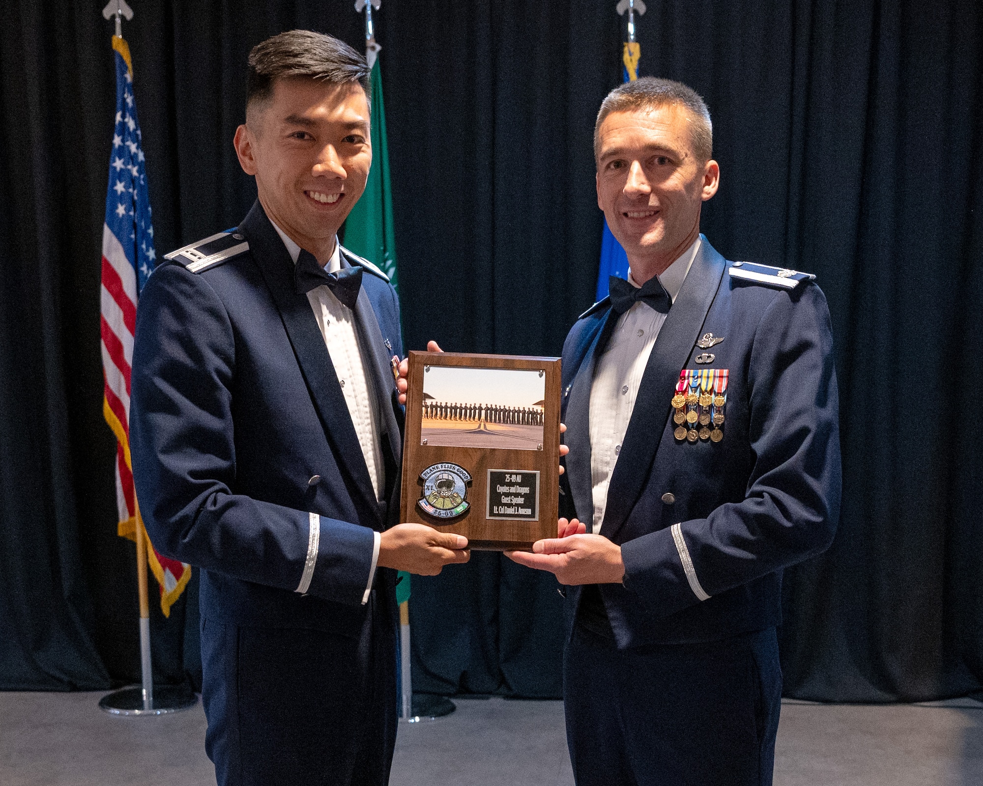 U.S. Air Force Capt. Heip Du, left, 47th Student Squadron student pilot, presents a token of appreciation to Lt. Col. Daniel Arneson, right, 446th Operations Group deputy commander, at Laughlin Air Force Base, Texas, May 1, 2025. Lt. Col. Arneson spoke at the graduation of Class 25-09 about his history with Laughlin and his memories of flying as a student and as a First Assignment Instructor Pilot. (U.S. Air Force photo by Staff Sgt. Nicholas Larsen)