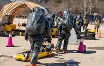 Soldiers from the 12th Civil Support Team, New Hampshire National Guard, transfer a notional victim to a decontamination line during a chemical, biological, radiological, and nuclear response exercise April 9, 2025, at Storyland in Glen, N.H.