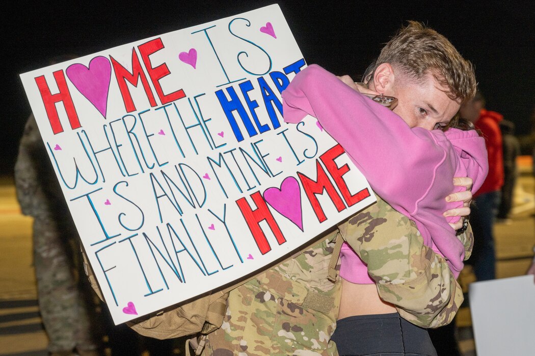 A couple hugs upon being reunited after deployment