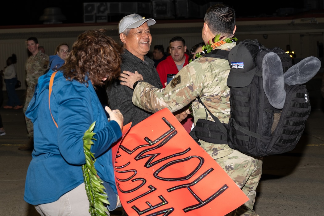 a family greets their loved one returning home from deployment