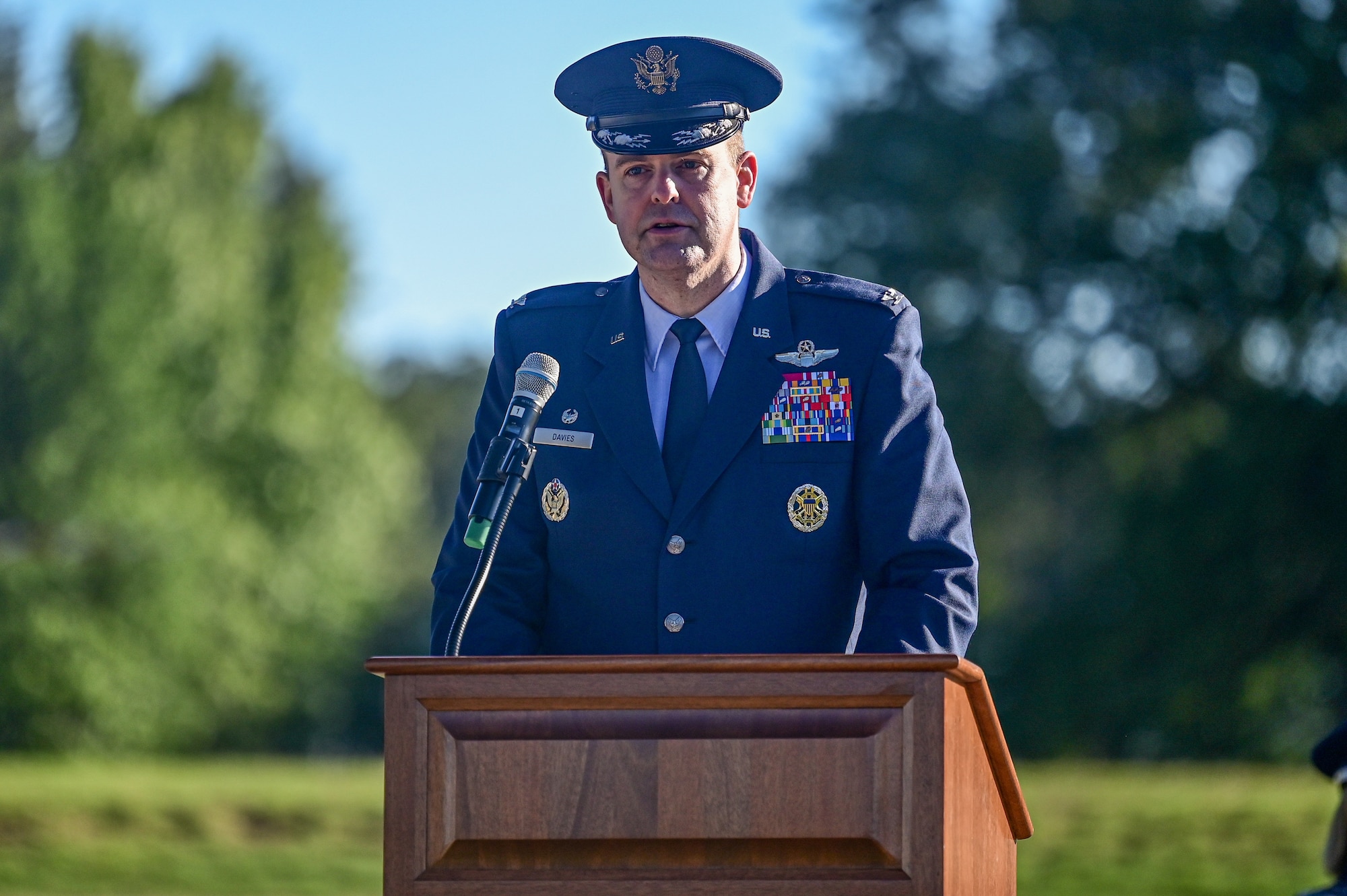 An Airman speaks behind a podium.
