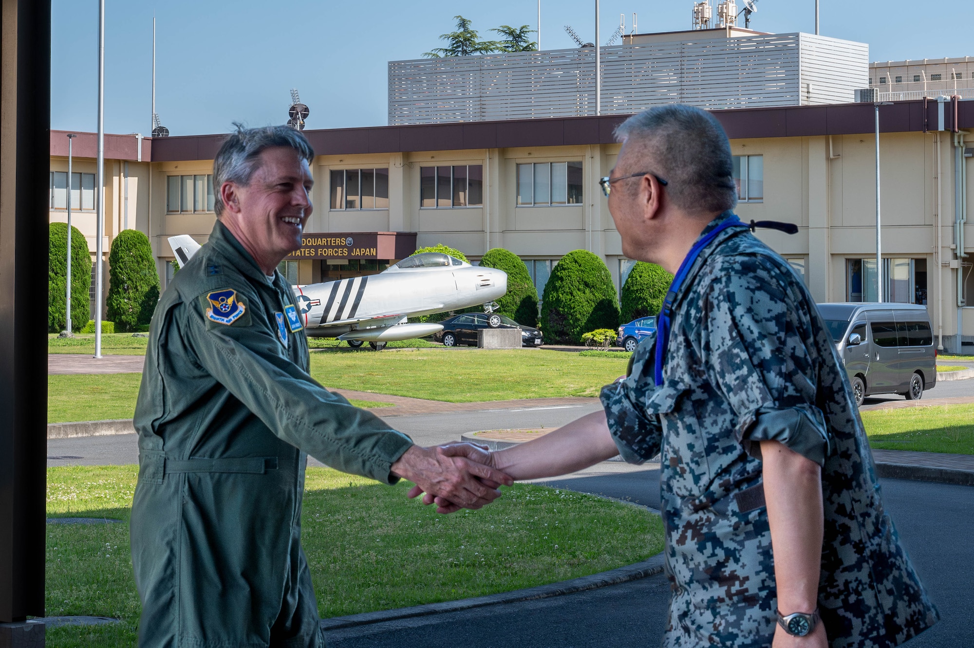 Maj. Gen. Jason Armagost, left, commander Eighth Air Force and Joint-Global Strike Operations Center, shakes hands with Japan Air Self-Defense Force Lt. Gen. Seiki Kageura, deputy commander of the Air Defense Command