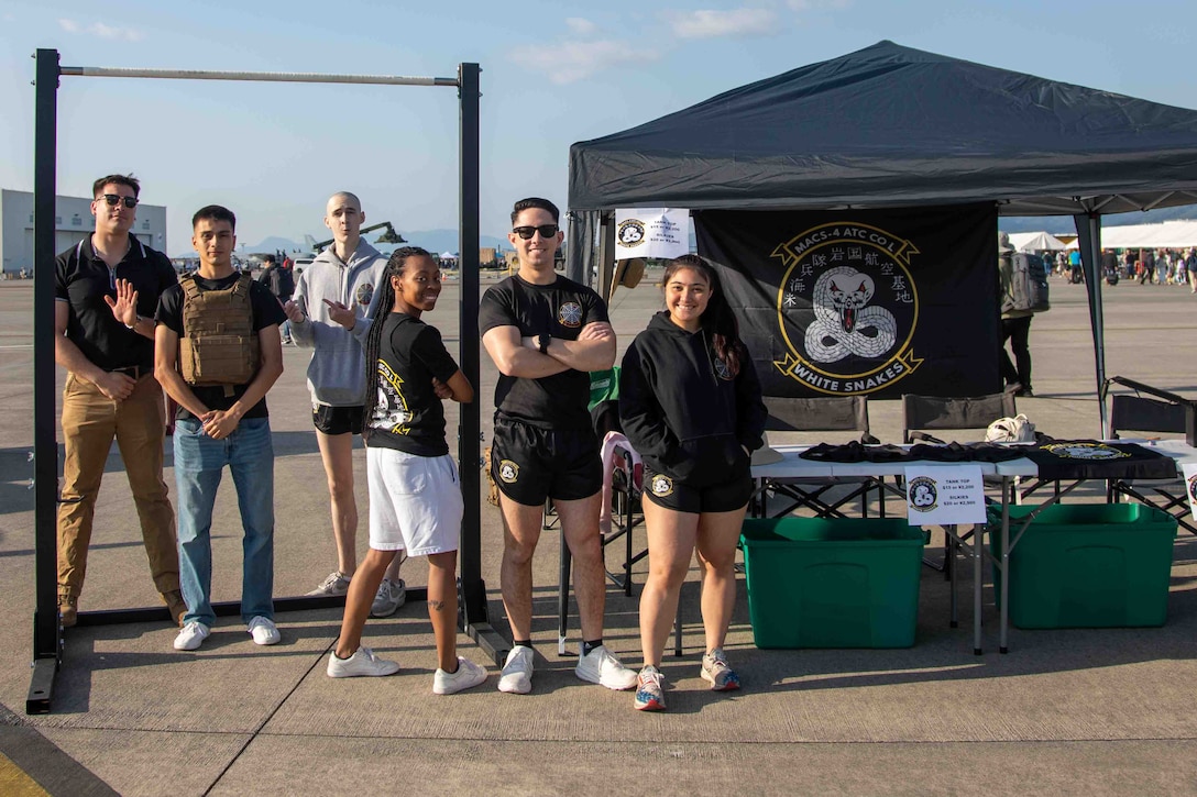 U.S. Marines with Marine Air Control Squadron (MACS) 4, 1st Marine Aircraft Wing, pose for a photo during the Japan Maritime Self-Defense Force-Marine Corps Air Station Iwakuni Friendship Day at MCAS Iwakuni, Japan, May 4, 2025. The JMSDF-MCAS Iwakuni Friendship Day is hosted annually to strengthen relationships with the host community and offer a cultural exchange that highlights the mutual support between the U.S. and Japan. (U.S. Marine Corps photo by Lance Cpl. Rylan Adcock)