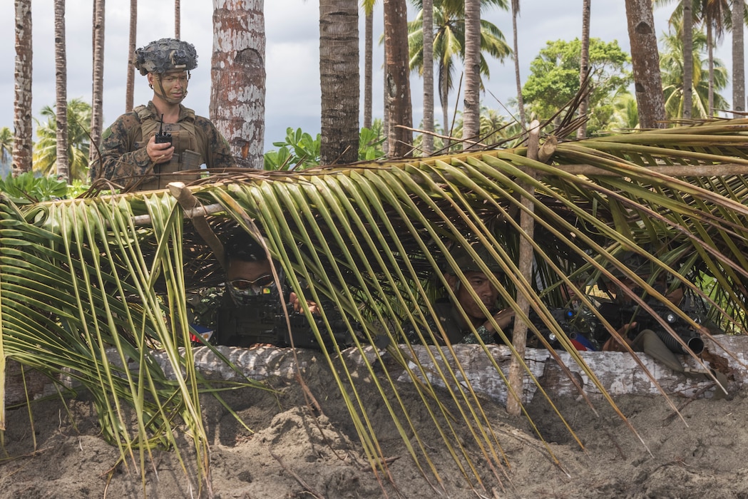 U.S. Marine Corps Cpl. Adam Clyne, an assistant patrol leader with 2nd Battalion, 1st Marine Regiment, Marine Rotational Force – Darwin 25.3, assists Philippine Marines with 3rd Marine Brigade, Philippine Marine Corps, as a personnel safety officer during a counter-landing live-fire rehearsal in support of Exercise Balikatan 25 at Rizal, Palawan, Philippines, April 27, 2025.