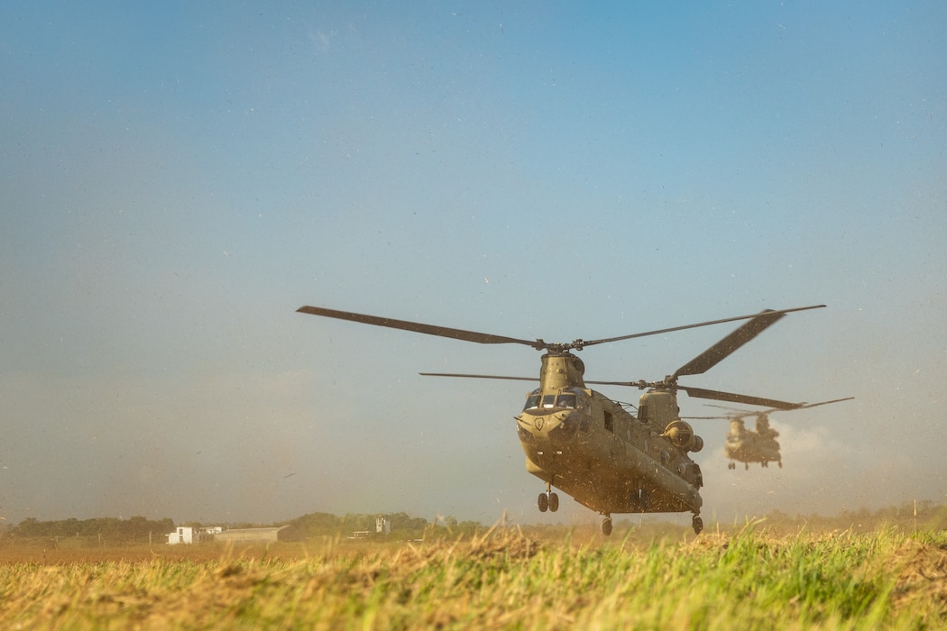 U.S. Army CH-47 Chinooks with 25th Combat Aviation Brigade, 25th Infantry Division, land while transporting U.S. Marines with 3d Littoral Combat Team, 3d Marine Littoral Regiment, 3d Marine Division, and Philippine Marines with Marine Battalion Landing Team 10, for the Maritime Key Terrain Security Operations event during Exercise Balikatan 25 in the Batanes island chain, Philippines, April 22, 2025.