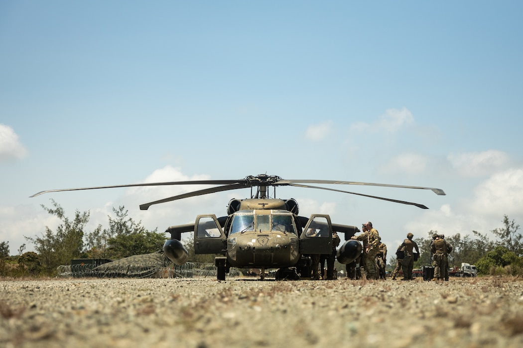 U.S. Marines with 3d Littoral Combat Team, 3d Marine Littoral Regiment, 3d Marine Division, and Philippine Marines with Marine Battalion Landing Team 10, load onto a U.S. Army UH-60 Black Hawk with 25th Combat Aviation Brigade, 25th Infantry Division, during the Maritime Key Terrain Security Operations event during Exercise Balikatan 25 in Northern Luzon, Philippines, April 22, 2025.