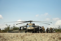 U.S. Marines with 3d Littoral Combat Team, 3d Marine Littoral Regiment, 3d Marine Division, and Philippine Marines with Marine Battalion Landing Team 10, load onto a U.S. Army UH-60 Black Hawk with 25th Combat Aviation Brigade, 25th Infantry Division, during the Maritime Key Terrain Security Operations event during Exercise Balikatan 25 in Northern Luzon, Philippines, April 22, 2025.