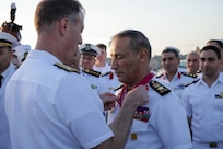 U.S. Navy Vice Adm. George Wikoff, commander of U.S. Naval Central Forces Command and U.S. Fifth Fleet, left, awards Egyptian Navy Vice Adm. Ashraf Ibrahim Atwa Megahed, commander of the Egyptian Navy, center, with a Legion of Merit medal aboard the Arleigh Burke-class guided-missile destroyer USS Truxtun (DDG 103) in the U.S. Central Command area of responsibility.