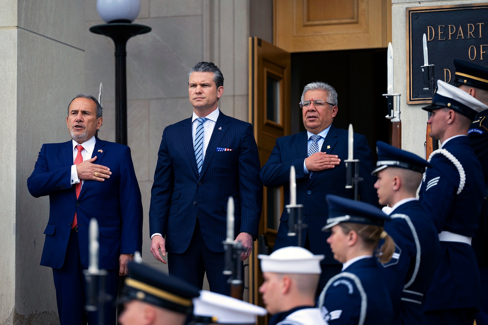 A close-up of three U.S. and Peruvian defense leaders during a ceremony at the Pentagon.