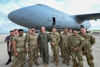 Col. Rick Kuehn, 512th Airlift Wing deputy wing commander, Lt. Col. Brandon Rodts, 433rd Maintenance Group deputy commander, Citizen Airmen from the 512th AW, and a 433rd AW civilian pose for a group photo during maintenance on a C-5M Super Galaxy at the 433rd Airlift Wing on Joint Base San Antonio-Lackland, Texas April 25, 2025.