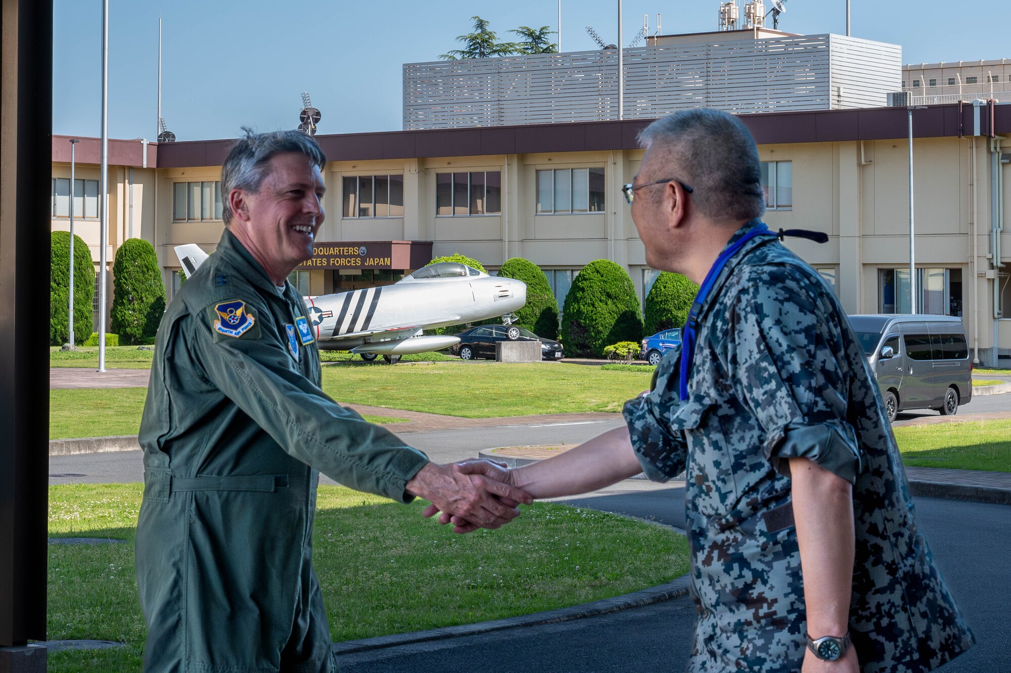 Maj. Gen. Jason Armagost, left, commander Eighth Air Force and Joint-Global Strike Operations Center, shakes hands with Japan Air Self-Defense Force Lt. Gen. Seiki Kageura, deputy commander of the Air Defense Command