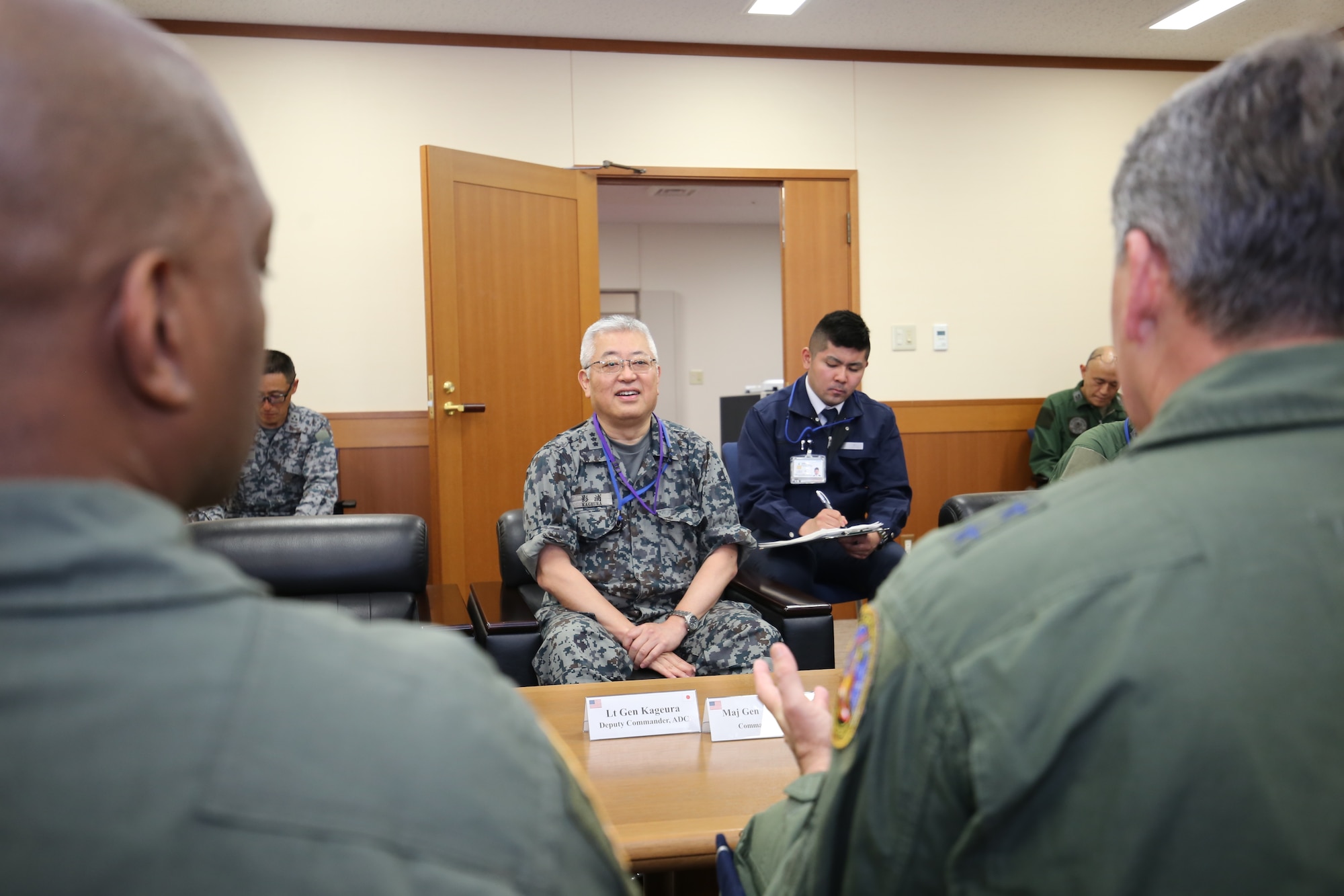 Japan Air Self-Defense Force Lt. Gen. Seiki Kageura, center, deputy commander of the Air Defense Command speaks with U.S. Air Force Chief Master Sgt. Ronnie Woods, left, Eighth Air Force Command Chief and U.S. Air Force Maj. Gen. Jason Armagost, commander Eighth Air Force and Joint-Global Strike Operations Center