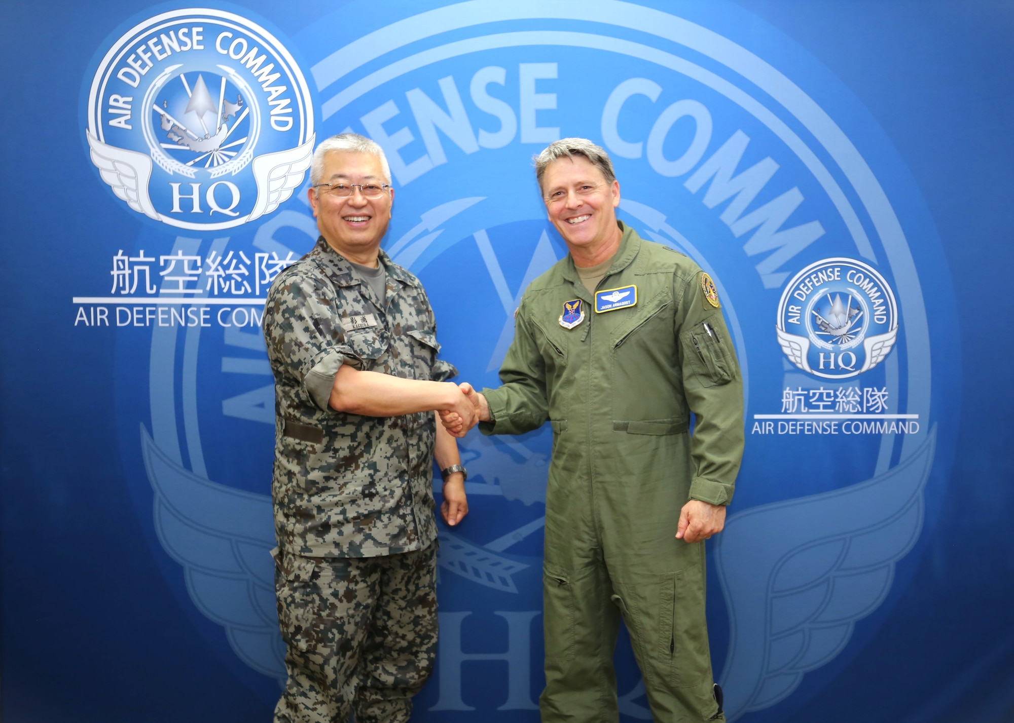 Japan Air Self-Defense Force Lt. Gen. Seiki Kageura, left, deputy commander of the Air Defense Command shakes U.S. Air Force Maj. Gen. Jason Armagost, commander Eighth Air Force and Joint-Global Strike Operations Center